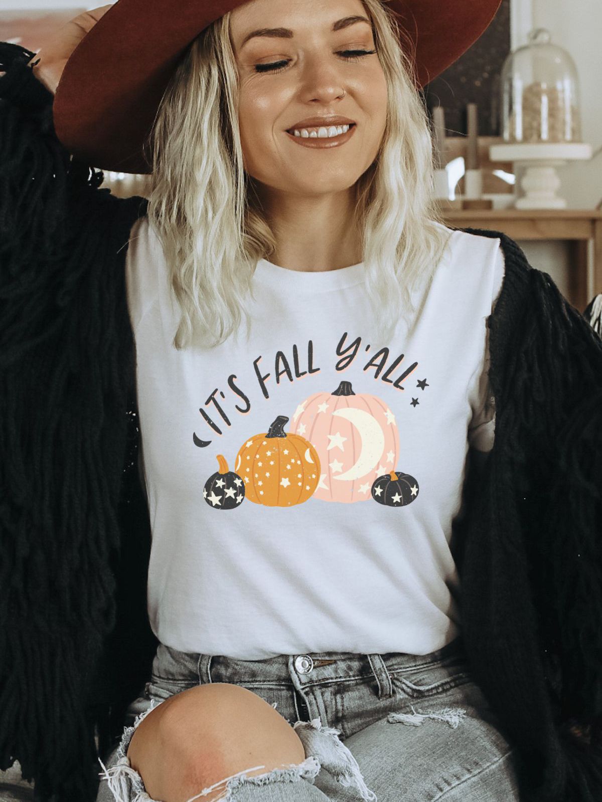 Woman wearing It's Fall Y'all t-shirt with pumpkins