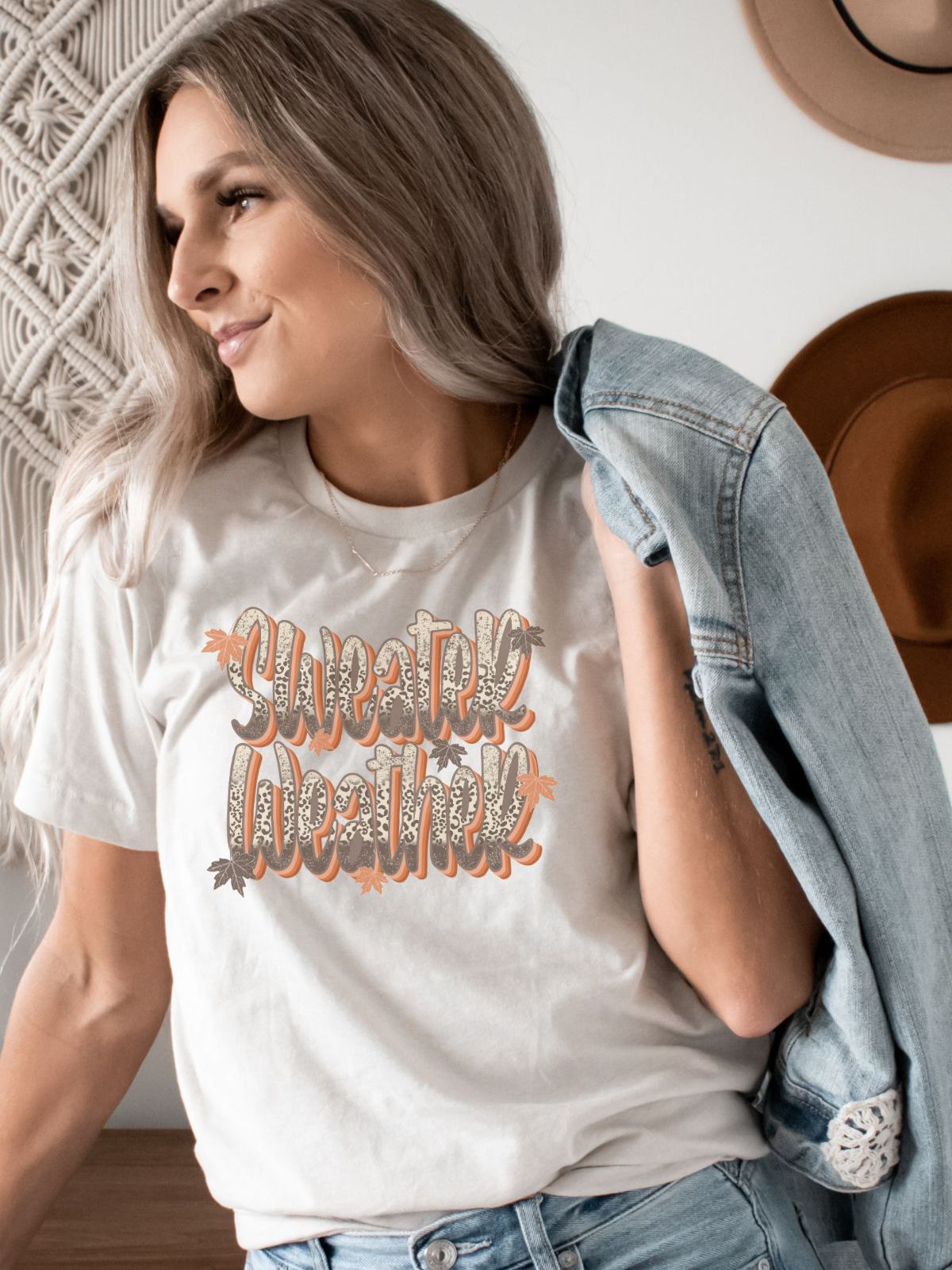 woman wearing sweater weather t-shirt