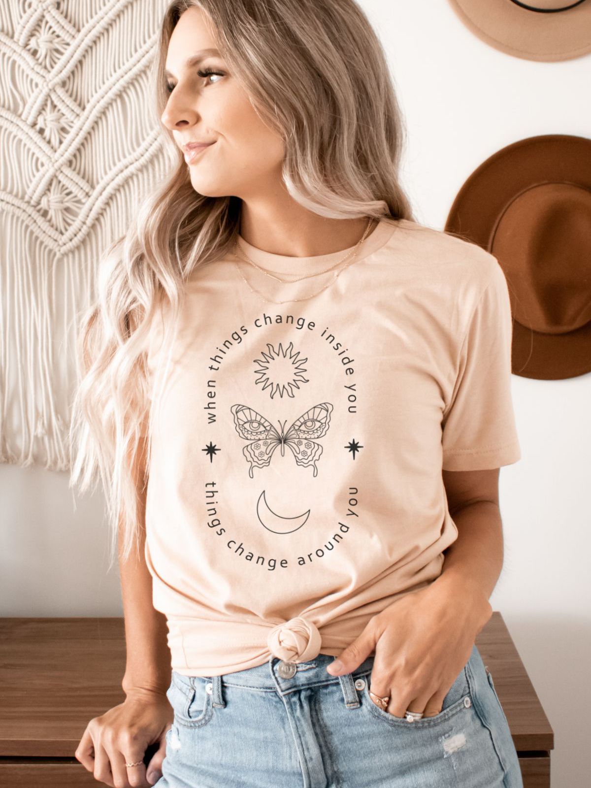 woman wearing a t-shirt with a butterfly and positive quote