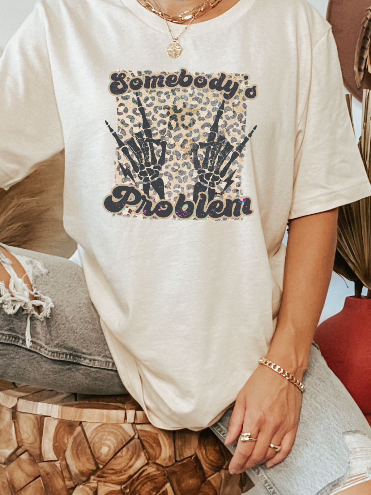 Unisex t-shirt with Somebody's Problem graphic and skeleton hands design