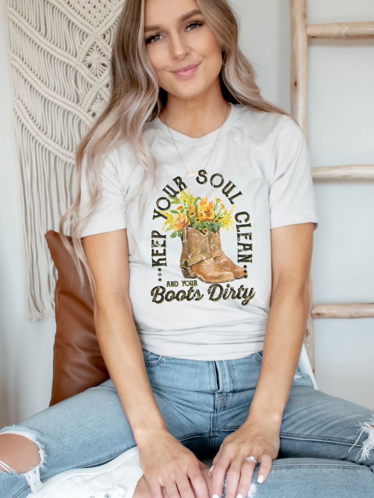 woman wearing t-shirt with Keep Your Soul Clean and Boots Dirty design