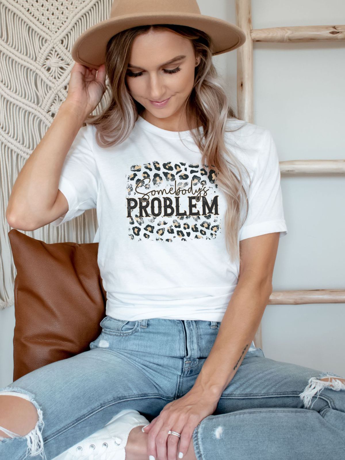 Woman wearing Somebodys Problem t-shirt with leopard print