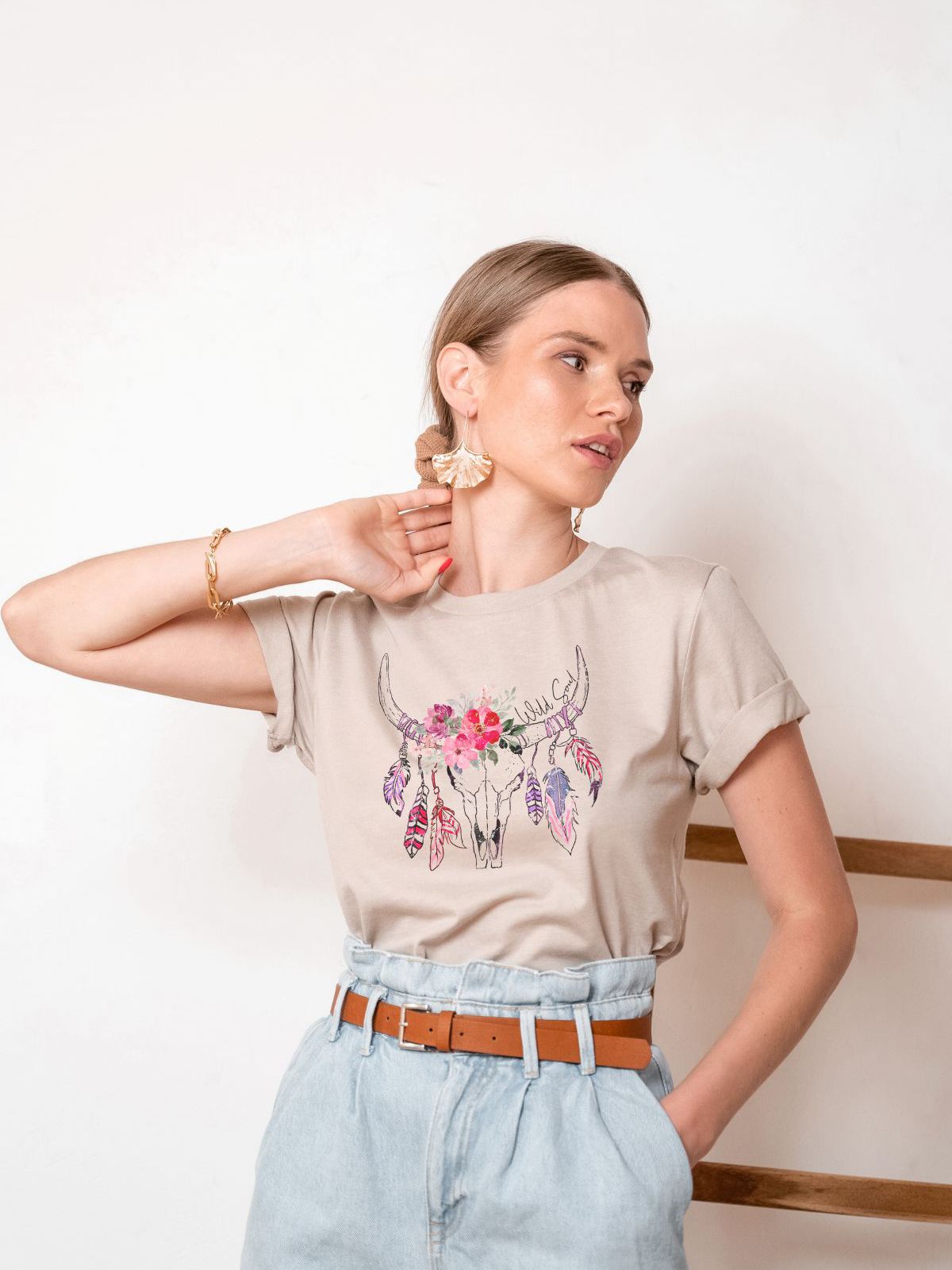 woman wearing beige t-shirt with floral bull skull design