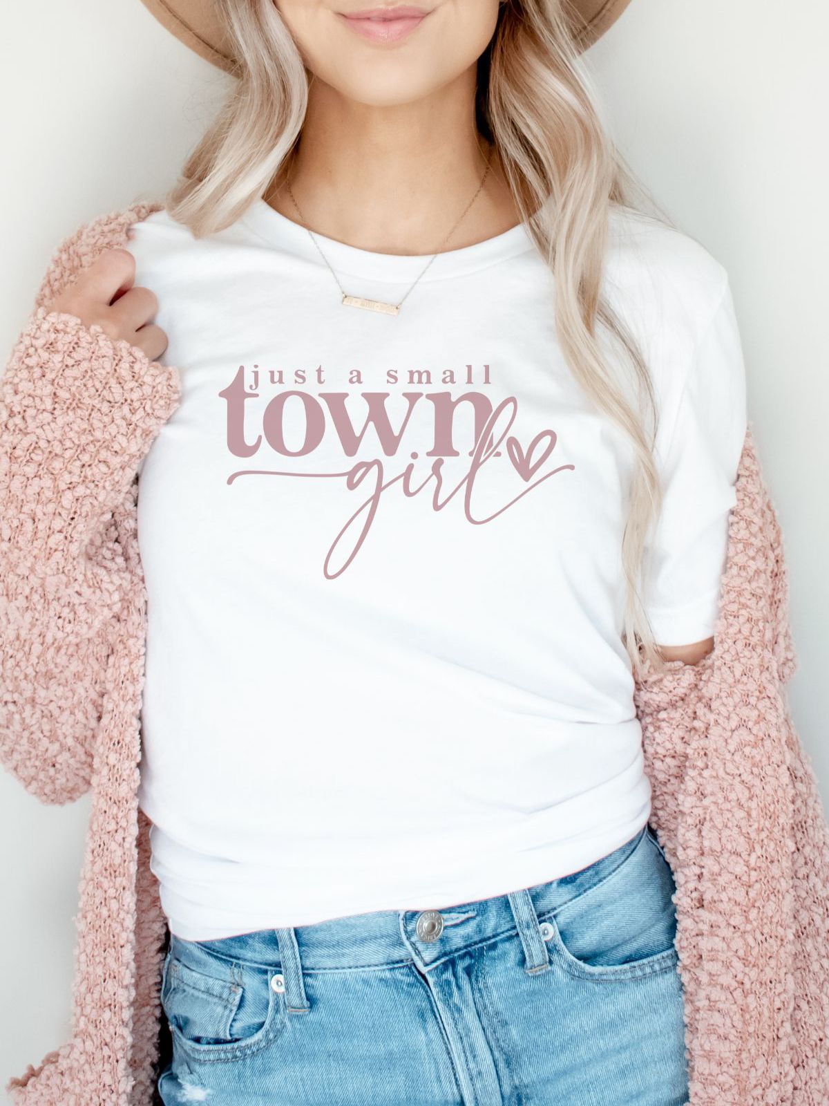 woman wearing just a small town girl white t-shirt