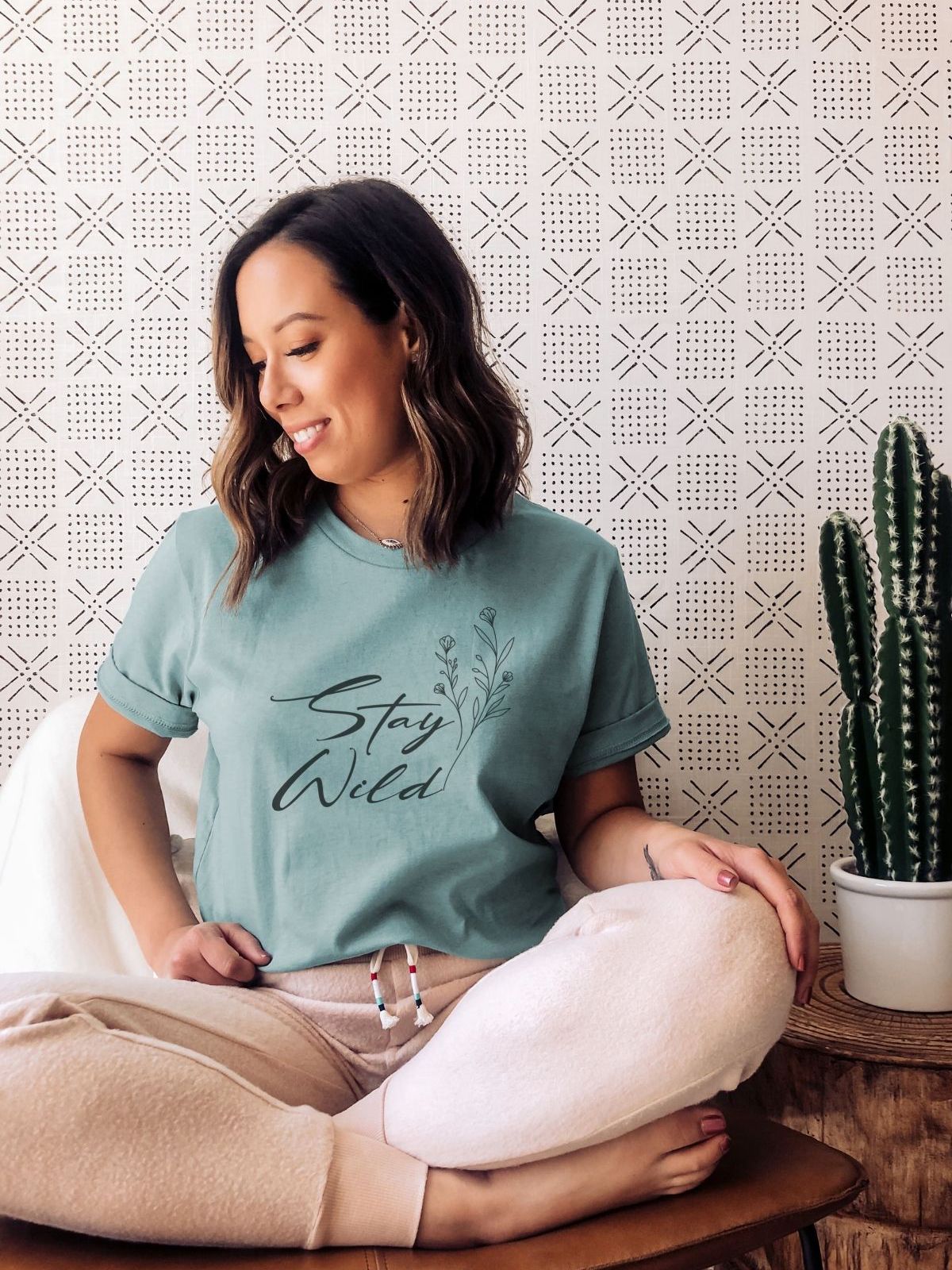 woman wearing Stay Wild graphic t-shirt
