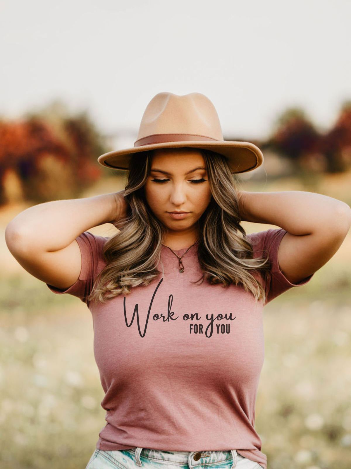 woman wearing a work on you for you t-shirt with hat