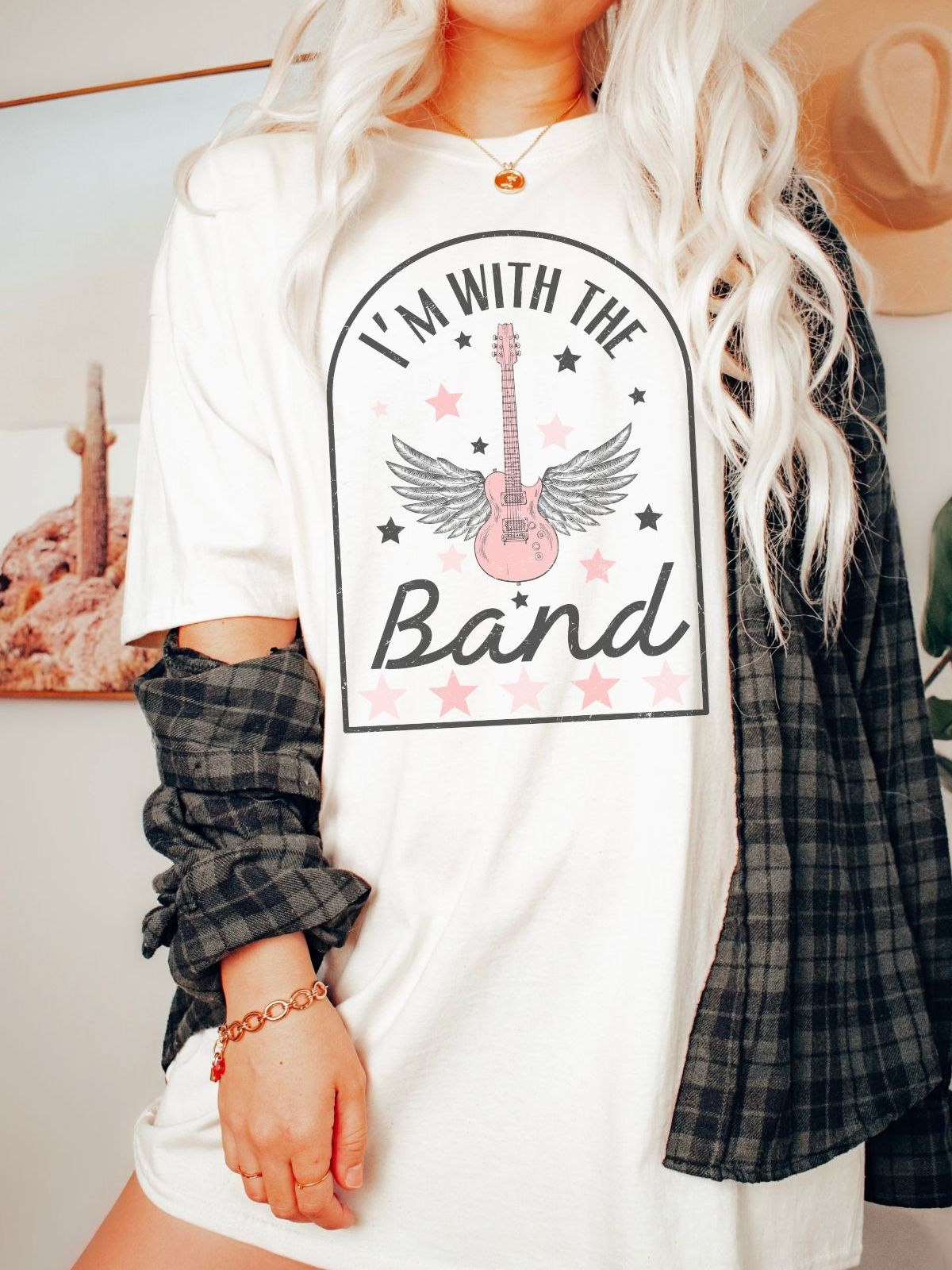 woman wearing I'm with the Band t-shirt with guitar and wings design