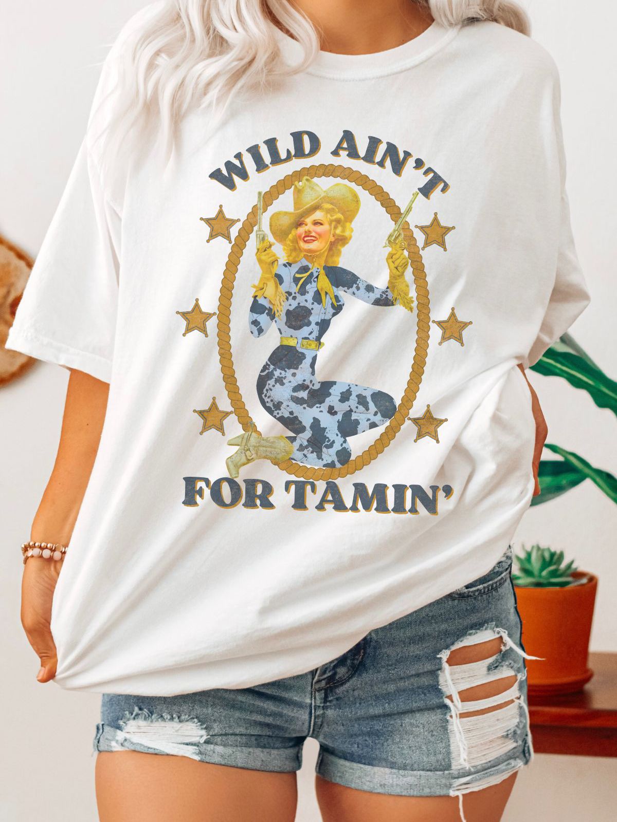 woman wearing Wild Ain't For Tamin' cowboy t-shirt