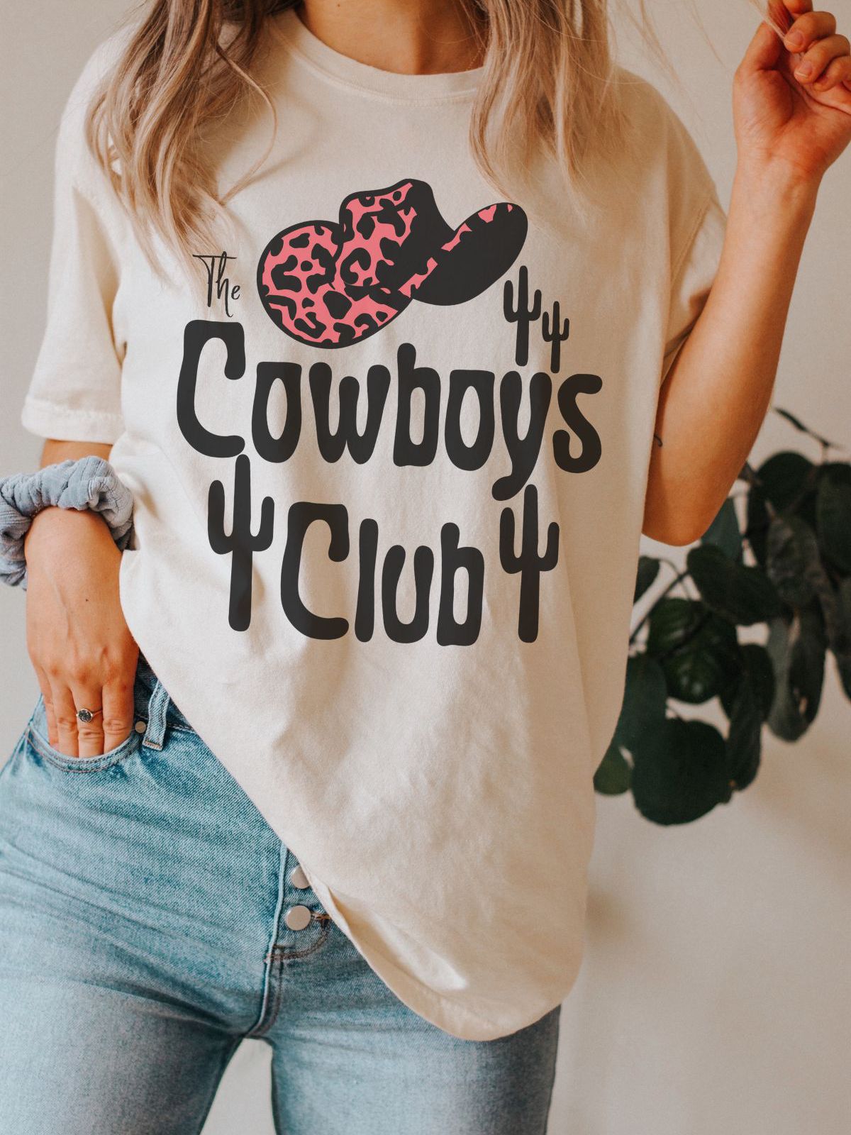 Woman wearing Cowboys Club t-shirt with hat design