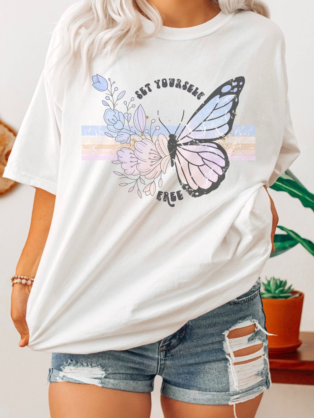 white t-shirt with butterfly and floral design