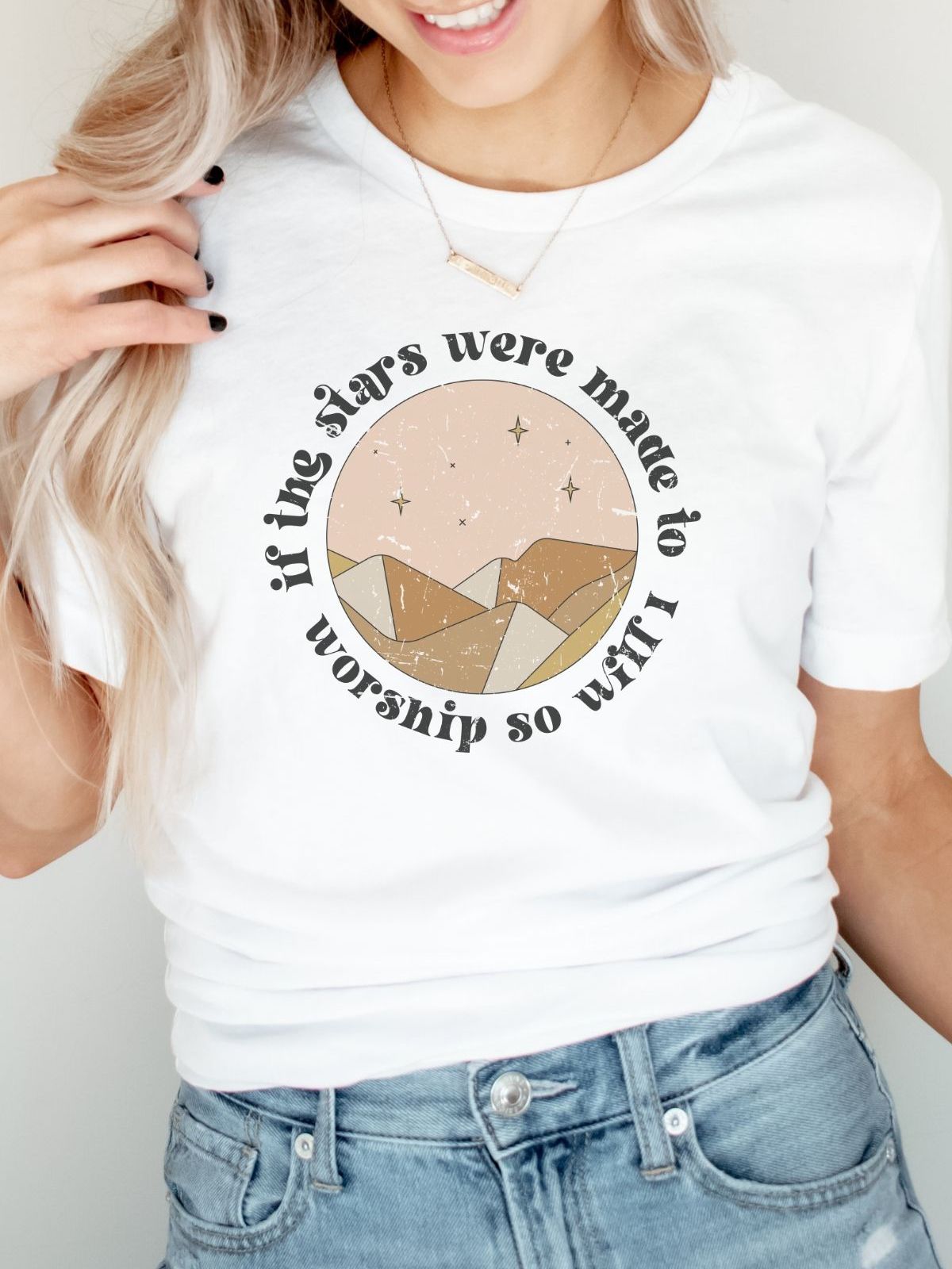 woman wearing t-shirt with stars worship design