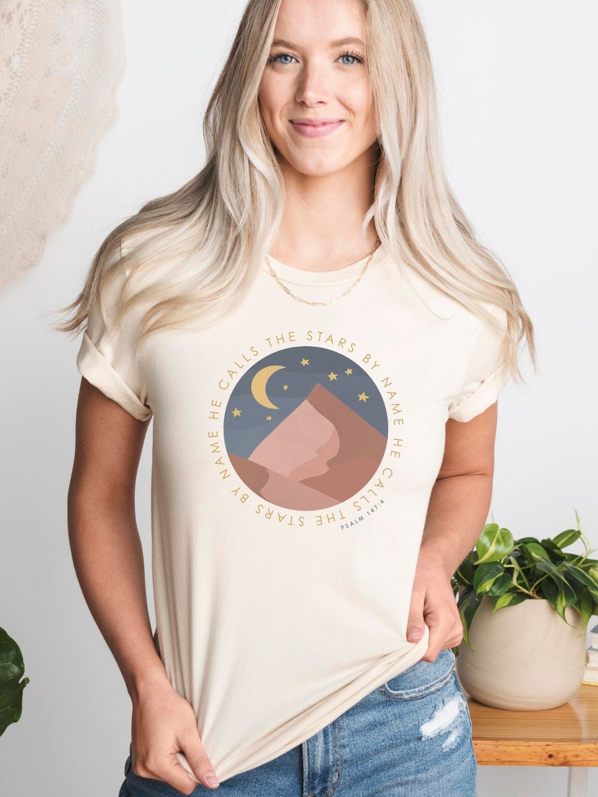 Woman wearing graphic t-shirt with stars and moon design
