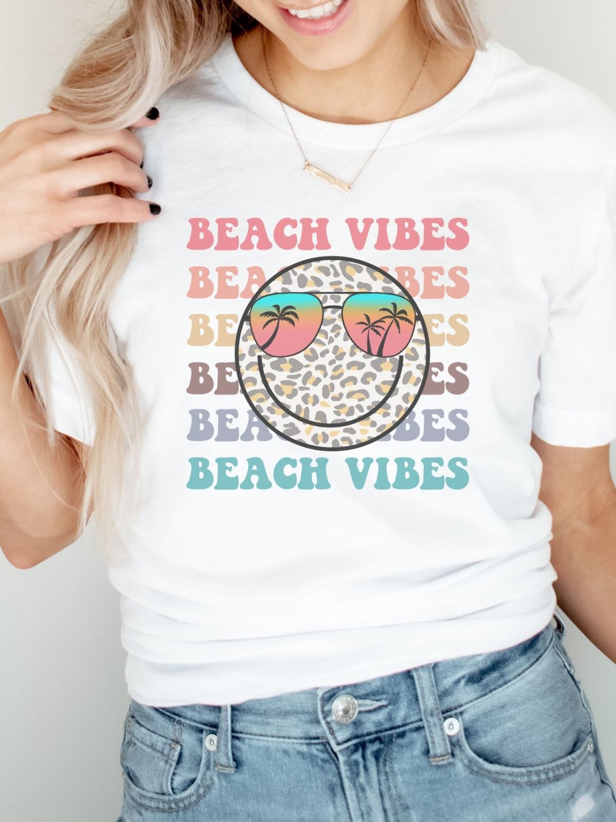 woman wearing white t-shirt with beach vibes design