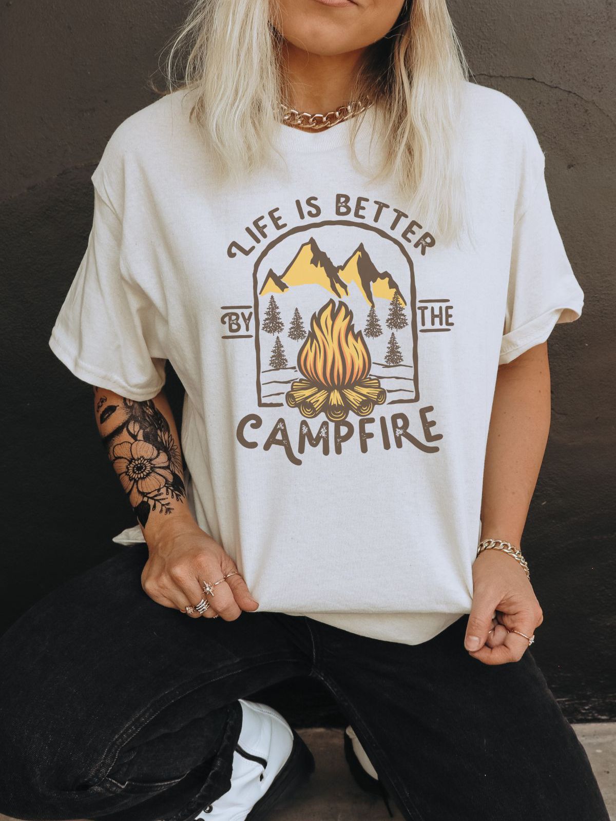 unisex t-shirt with campfire graphic and mountain scenery
