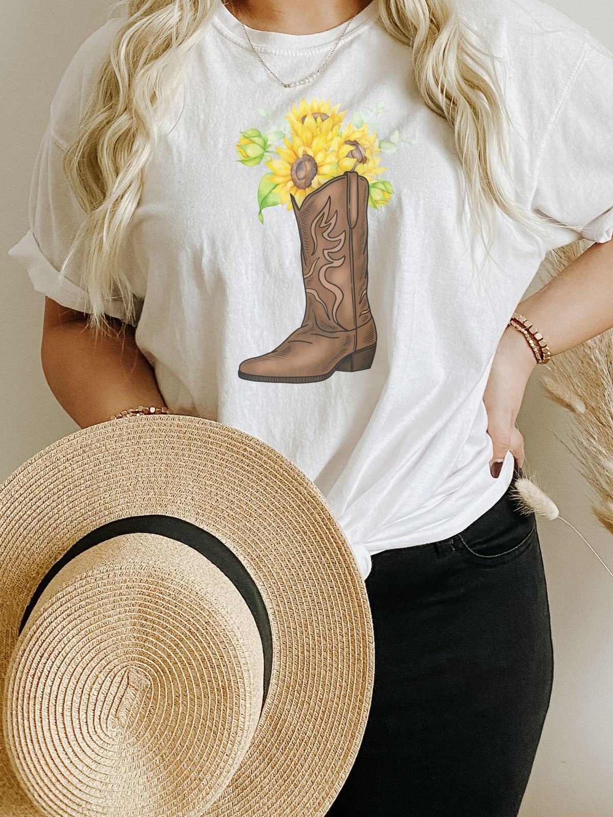 woman wearing white t-shirt with sunflower cowboy boot graphic