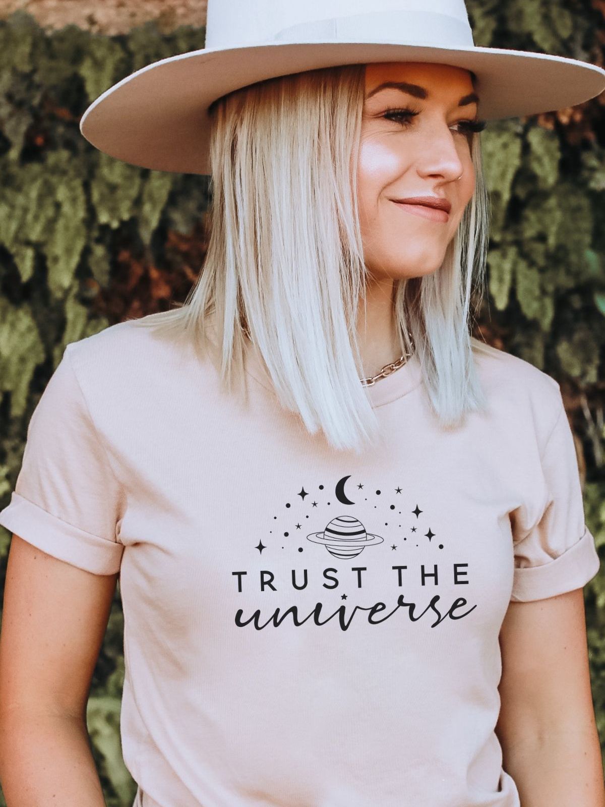 woman wearing a Trust the Universe t-shirt