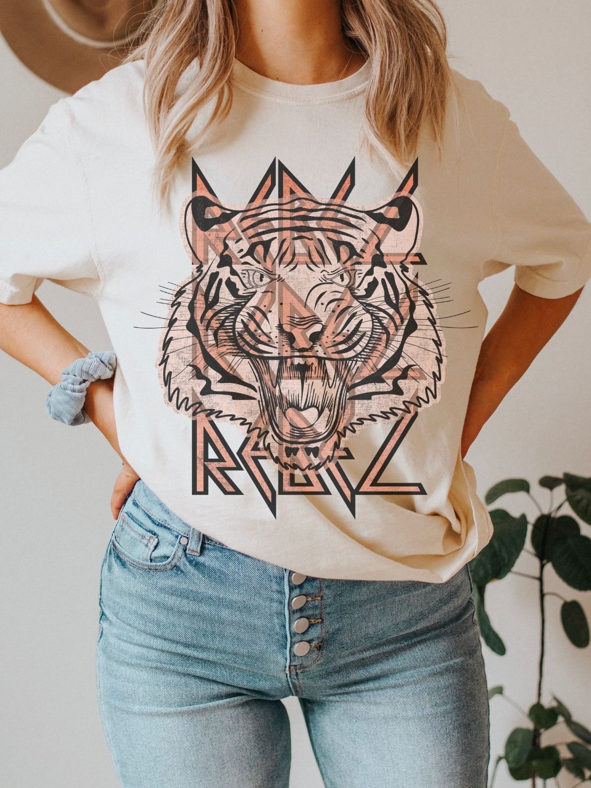 woman wearing a t-shirt with tiger design and rebel text