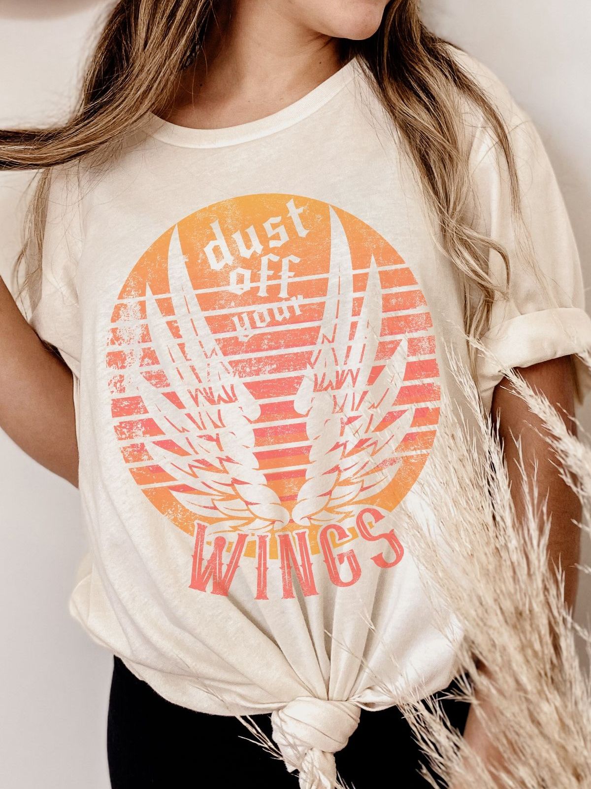 Woman wearing Dust Off Your Wings shirt