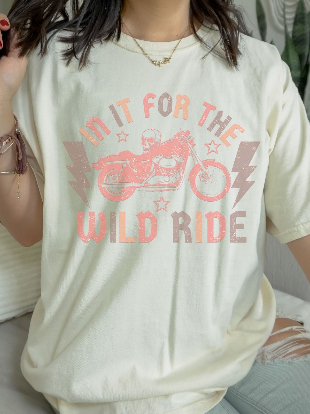 woman wearing shirt with motorcycle graphic and text in it for the wild ride