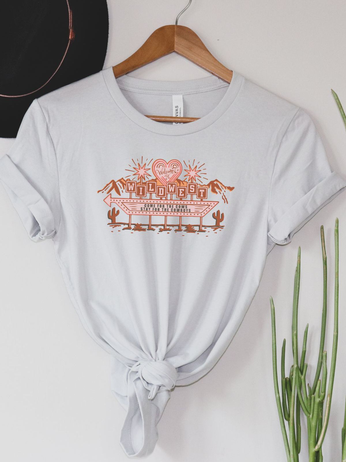 Wild West themed women's t-shirt hanging on a hanger