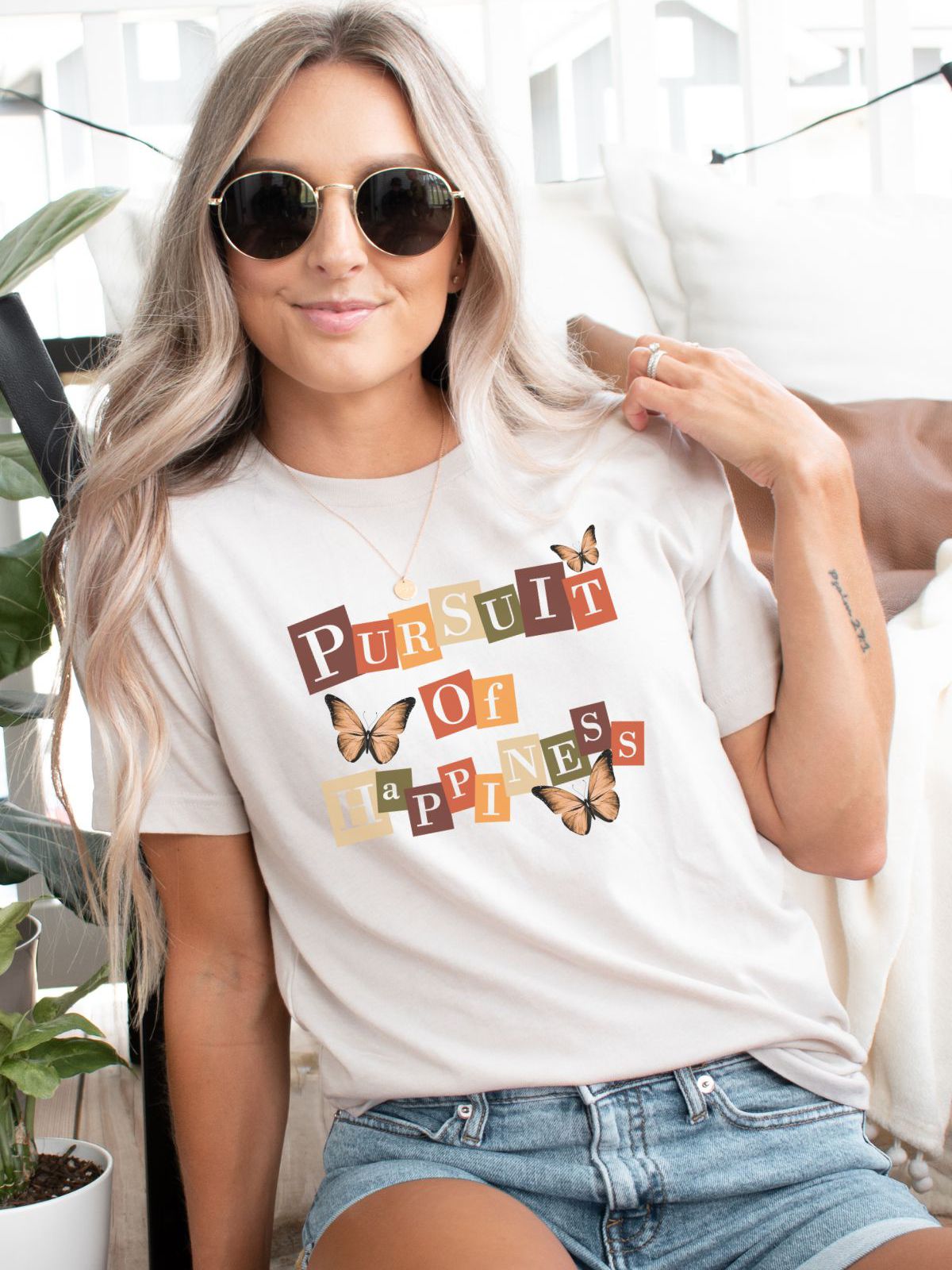 woman wearing pursuit of happiness butterfly t-shirt