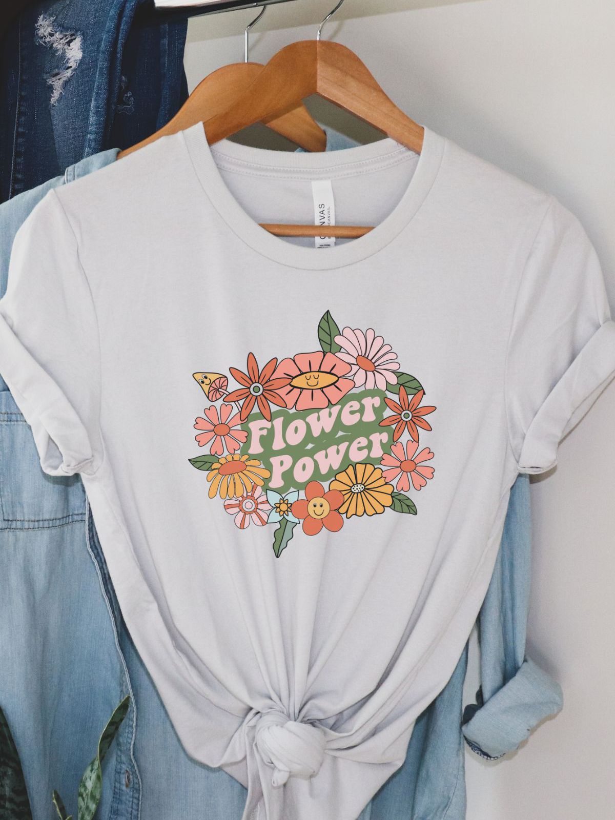 White t-shirt with flower power print hanging on a hanger