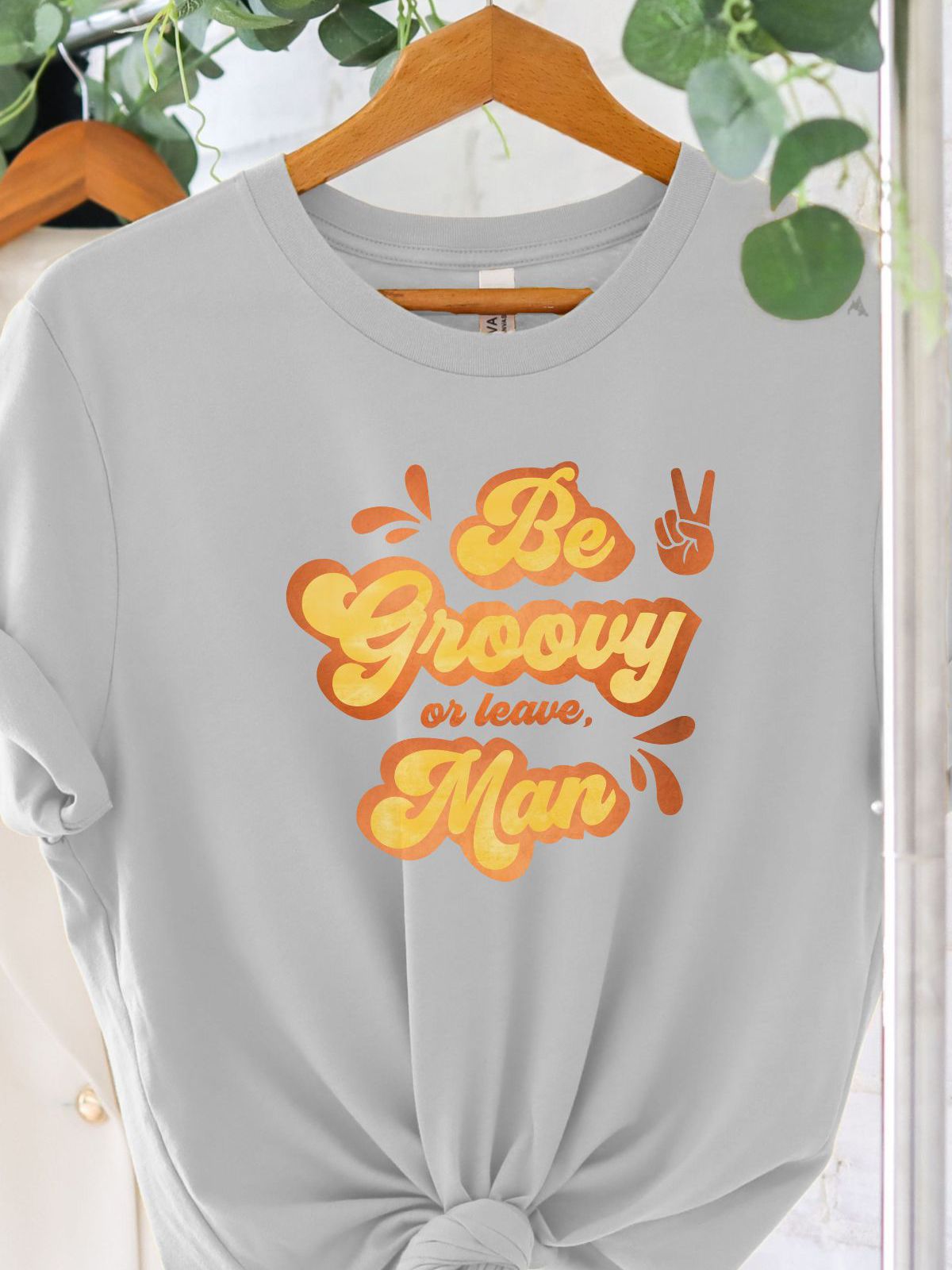 gray t-shirt with be groovy or leave man text design