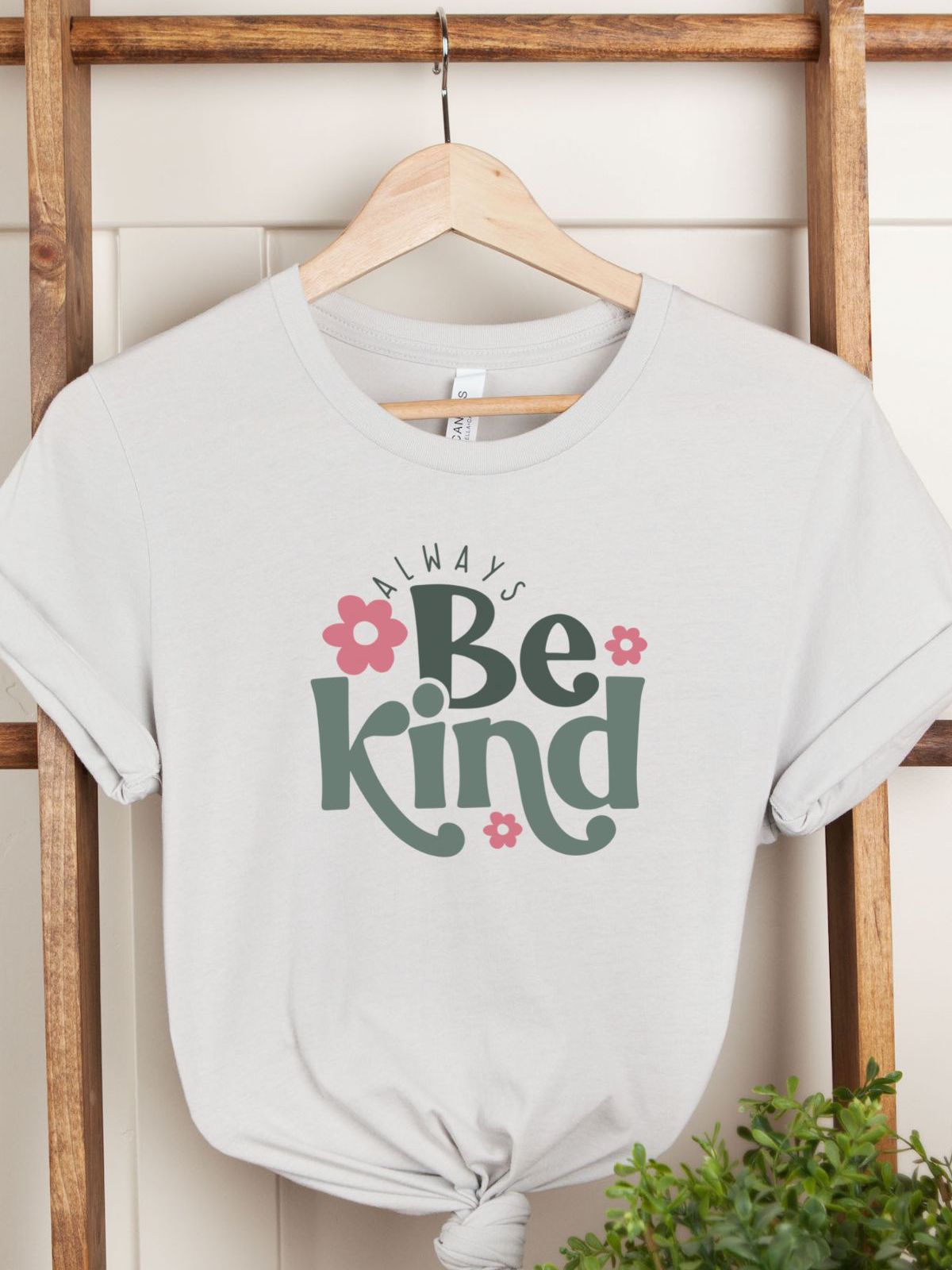 Always Be Kind women t-shirt with floral design on hanger