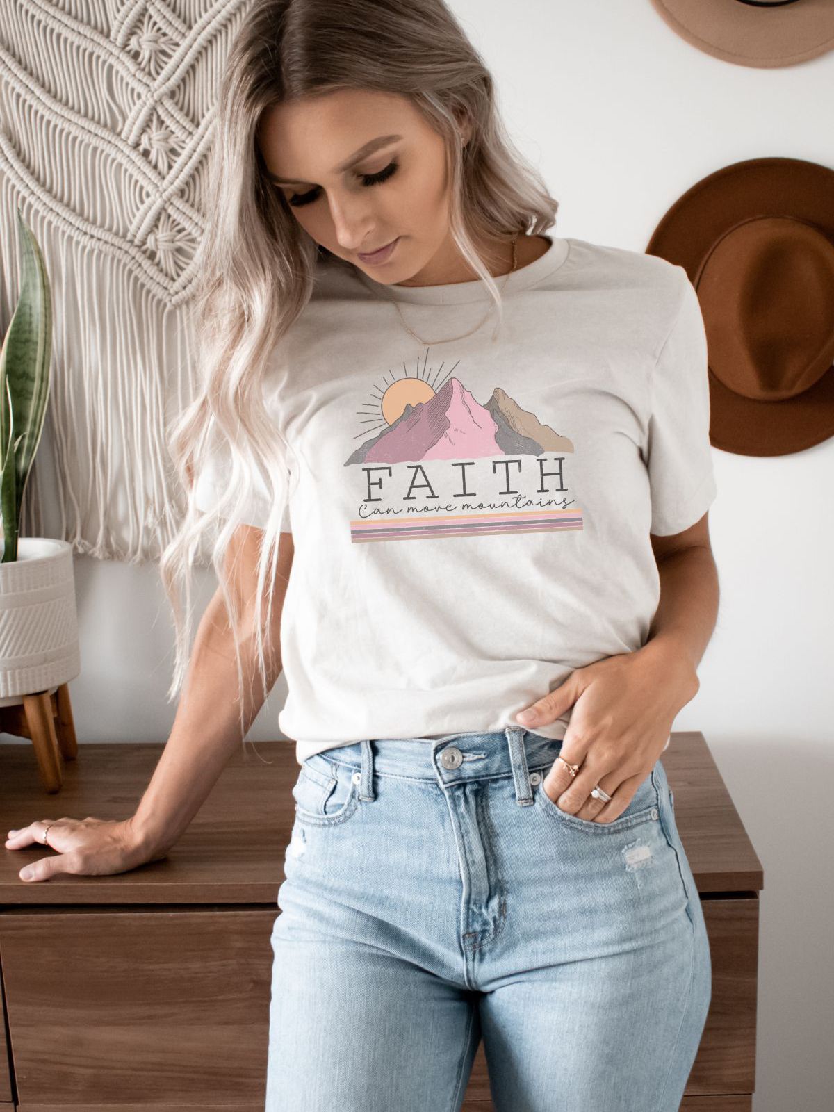Woman wearing Faith graphic t-shirt with mountains