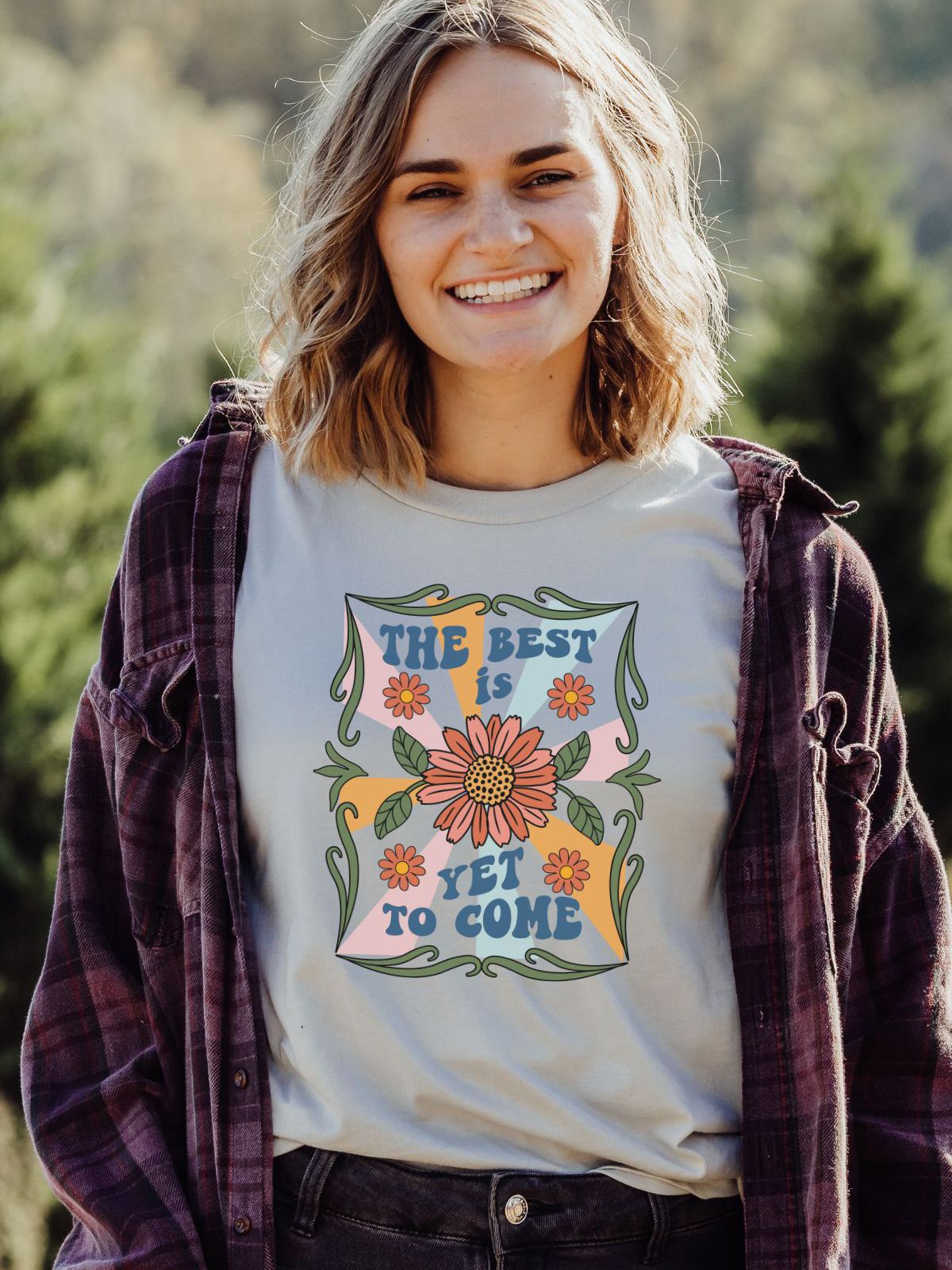 Woman wearing a t-shirt with 'The Best Is Yet To Come' design