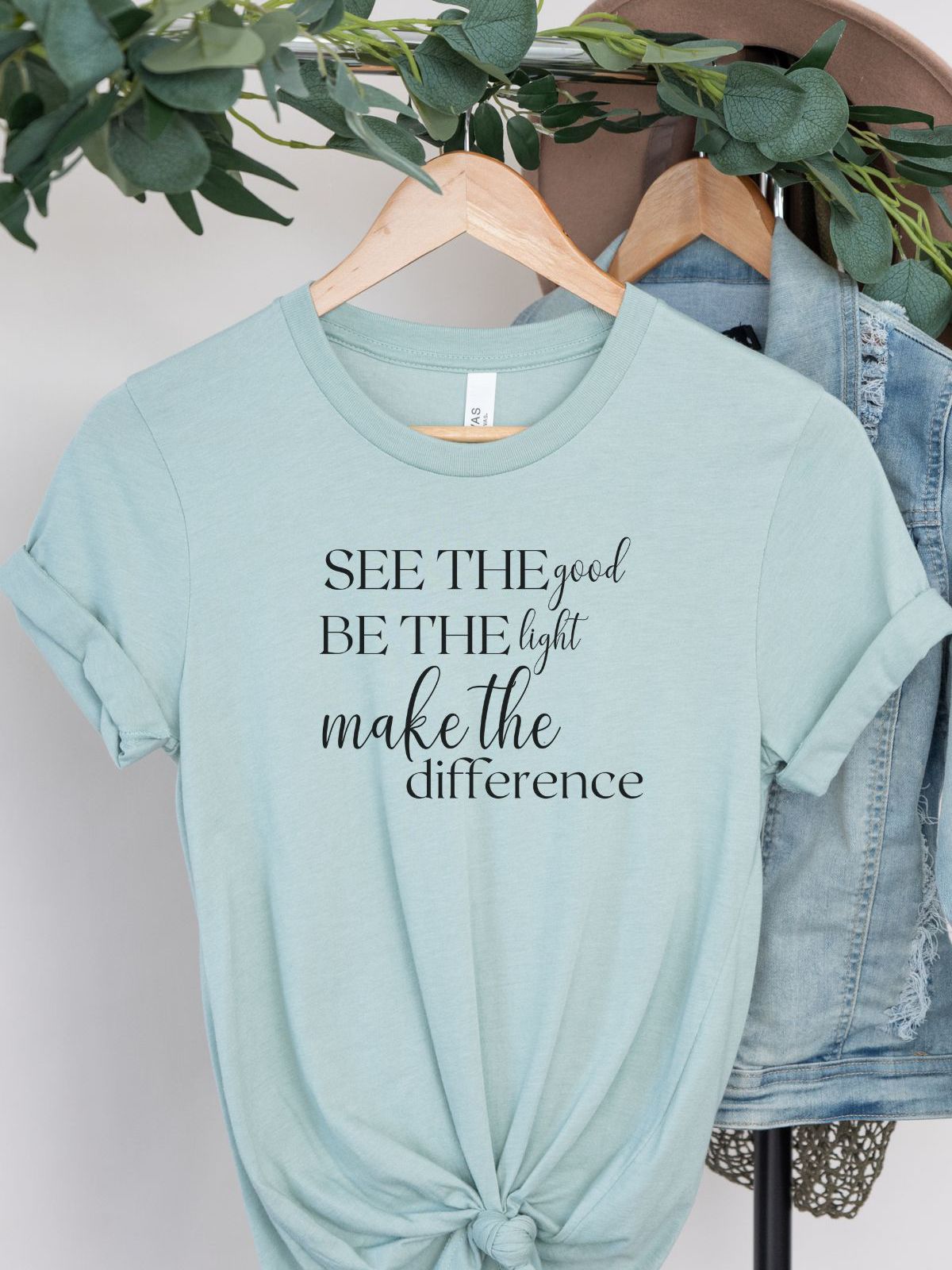light blue t-shirt with see the good be the light make the difference text