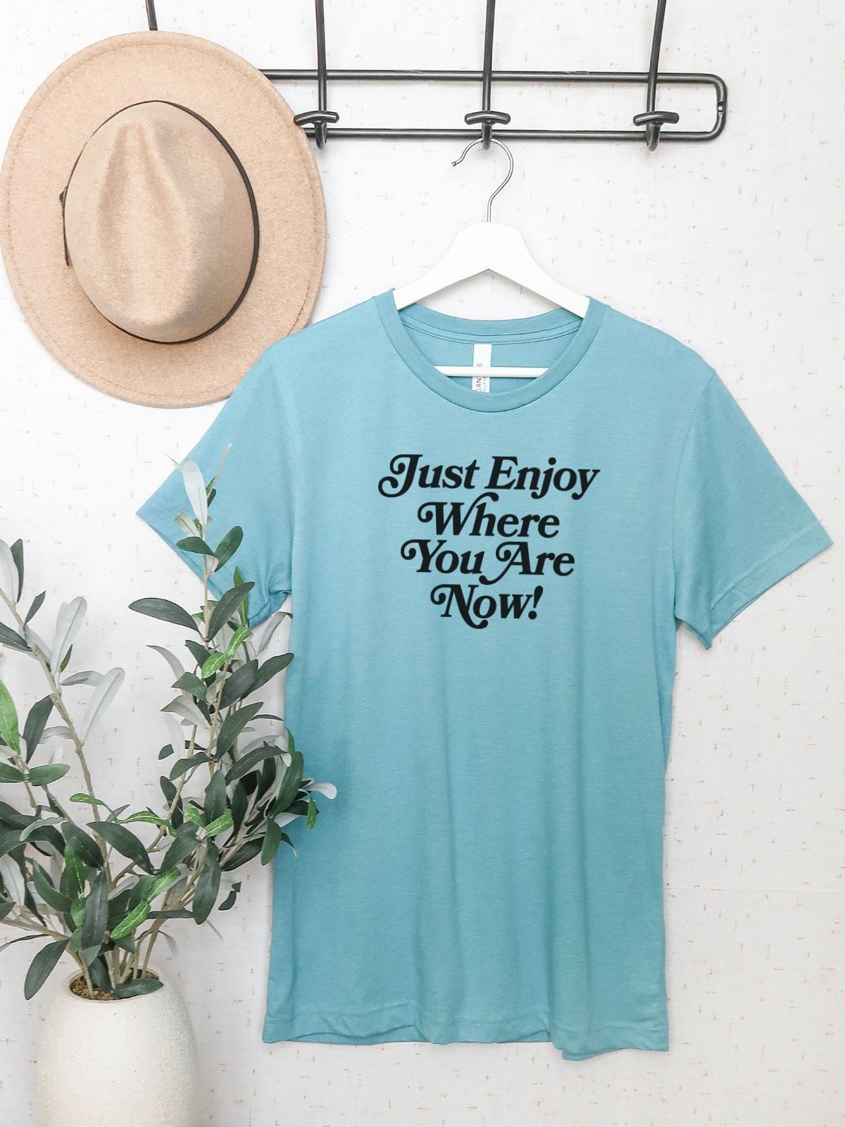 blue t-shirt with text Just Enjoy Where You Are Now