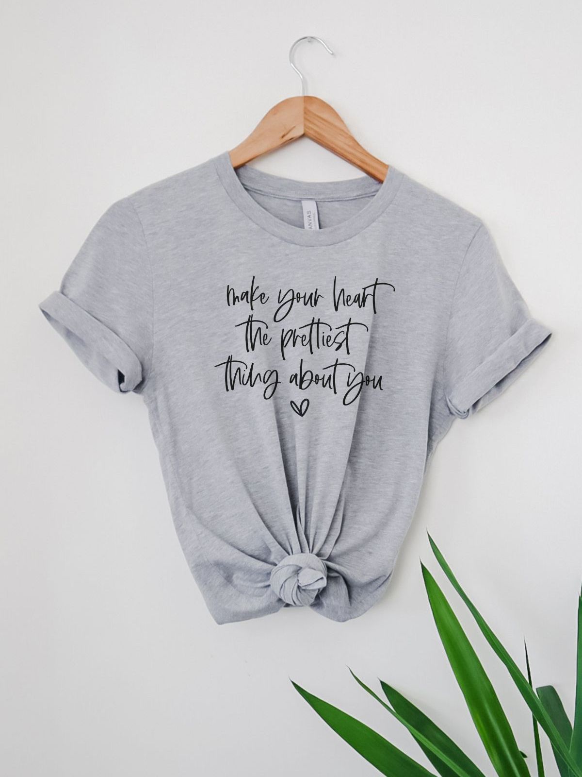 Gray t-shirt with inspirational heart quote hanging on a hanger