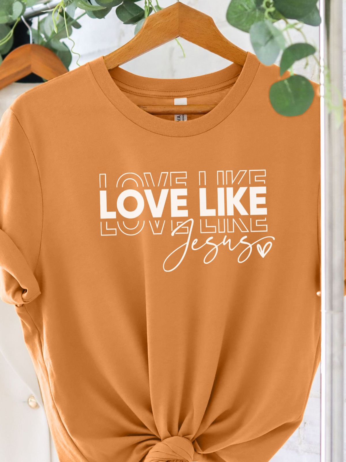 Love Like Jesus graphic t-shirt on hanger