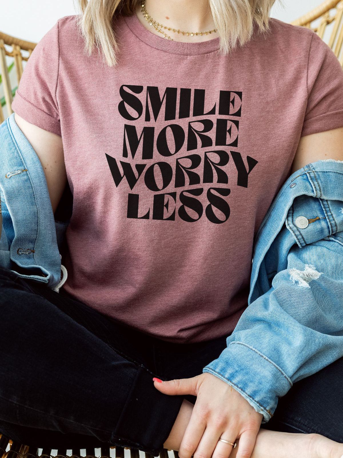 woman wearing a smile more worry less t-shirt