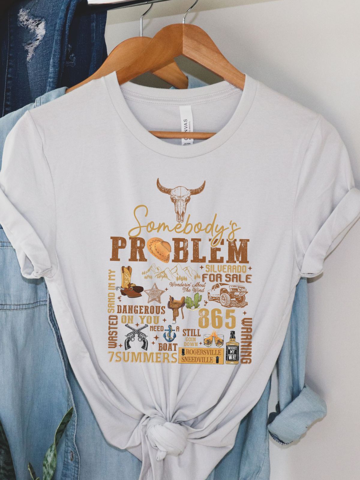 White t-shirt with country-themed Somebody's Problem design
