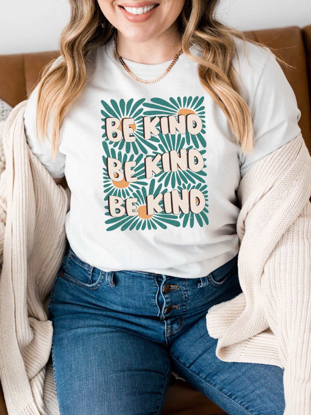 woman wearing be kind t-shirt with floral design