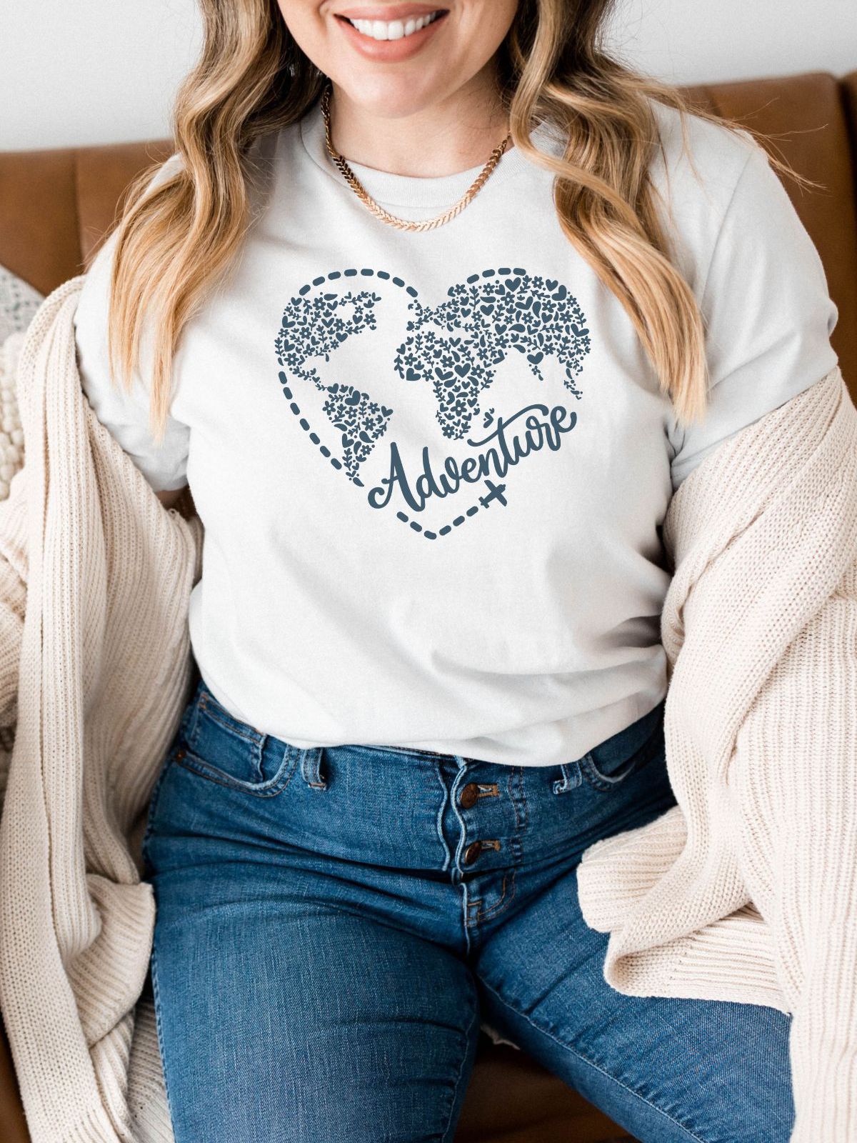 Woman in Adventure graphic t-shirt sitting