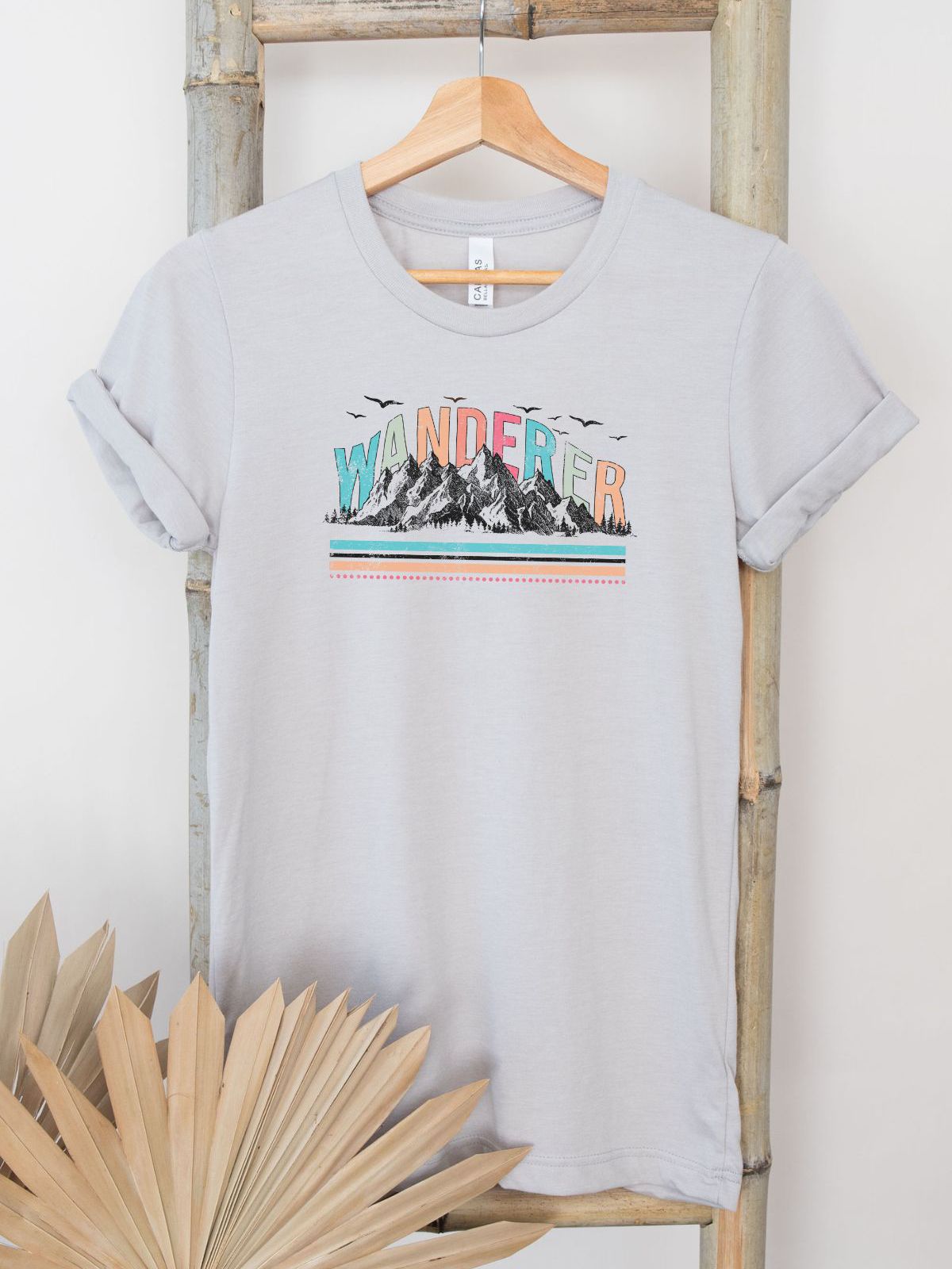Wanderer unisex t-shirt with mountain design on hanger