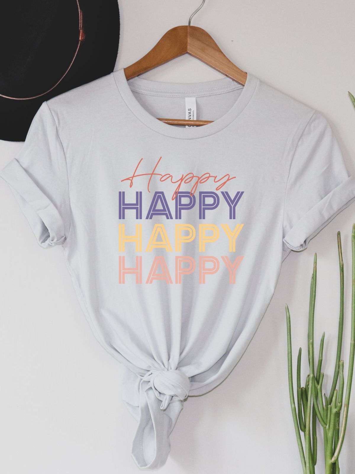 White t-shirt with Happy text design on hanger