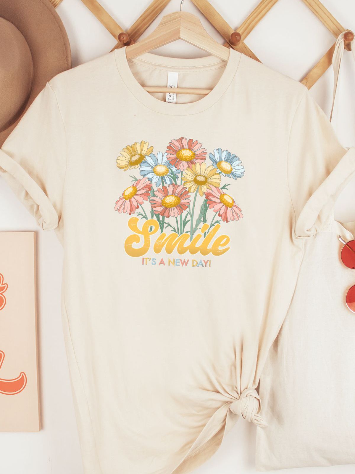 beige t-shirt with colorful flowers and smile text