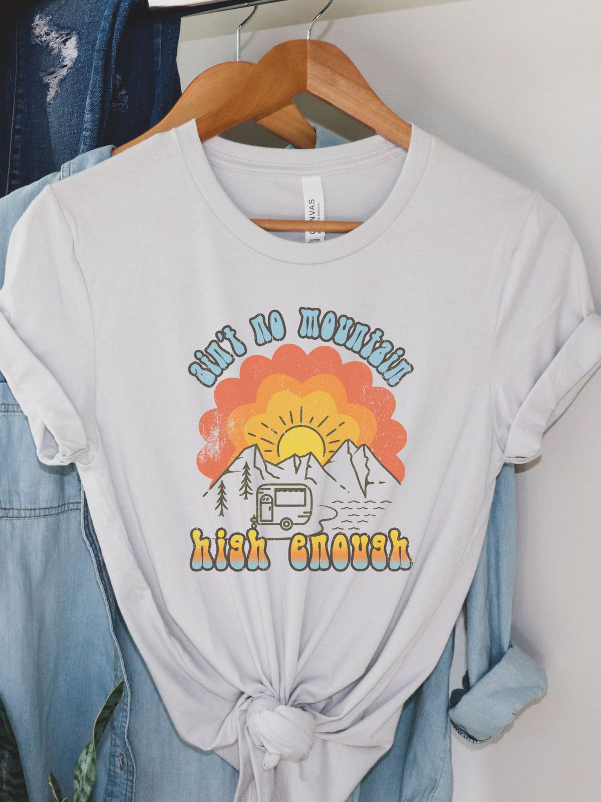 Graphic t-shirt with sunset mountains and camper design