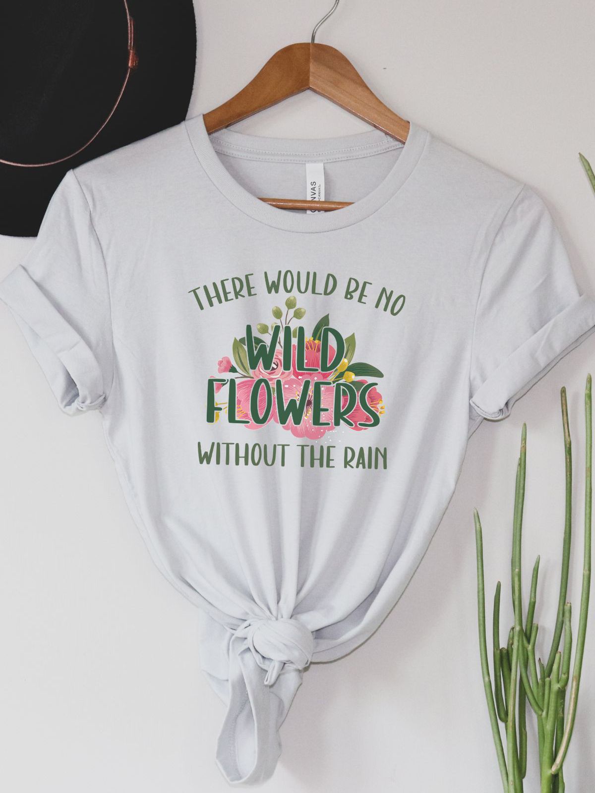 white t-shirt with wild flowers design and text