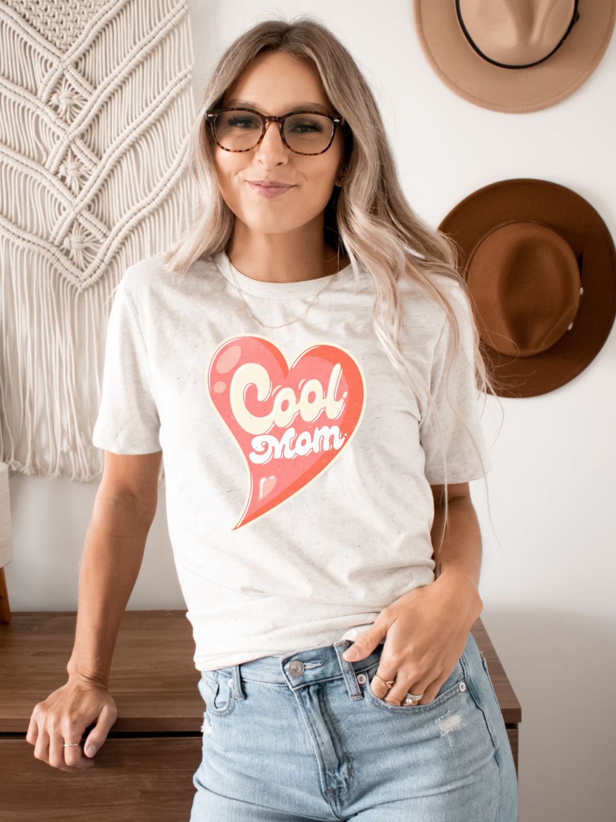 Woman wearing a Cool Mom t-shirt with heart design