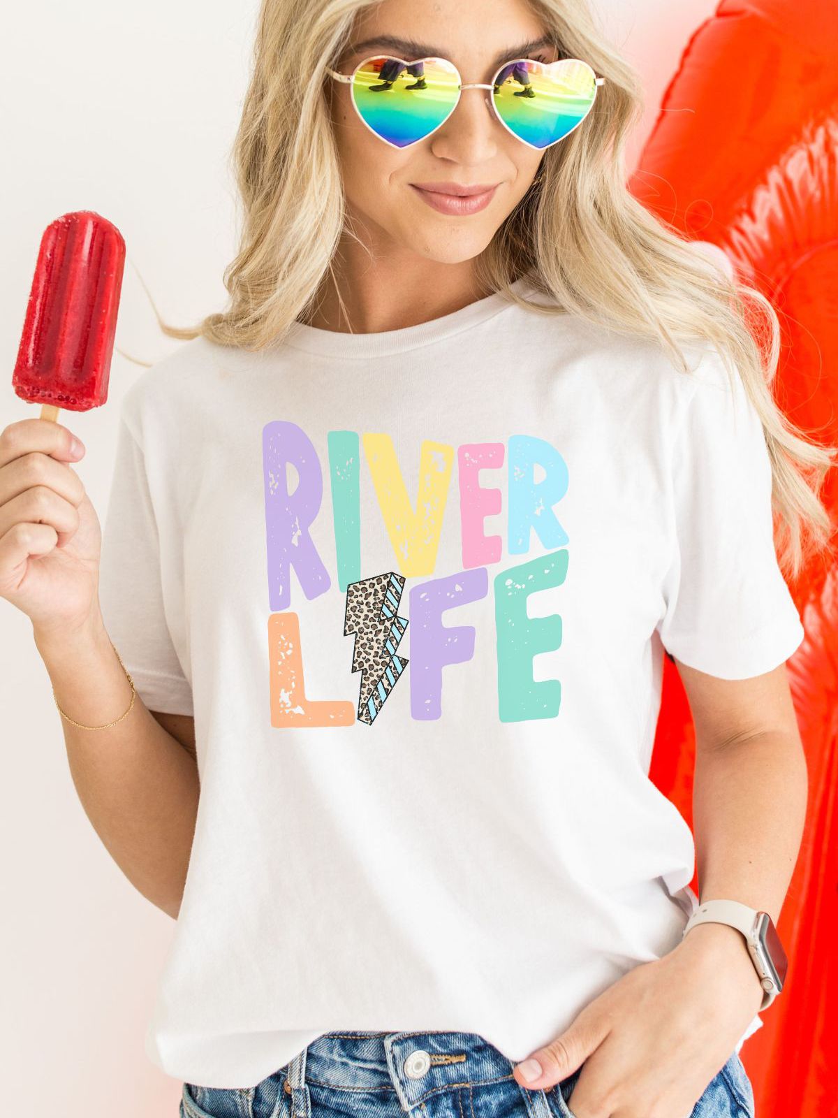 woman wearing River Life t-shirt with colorful design