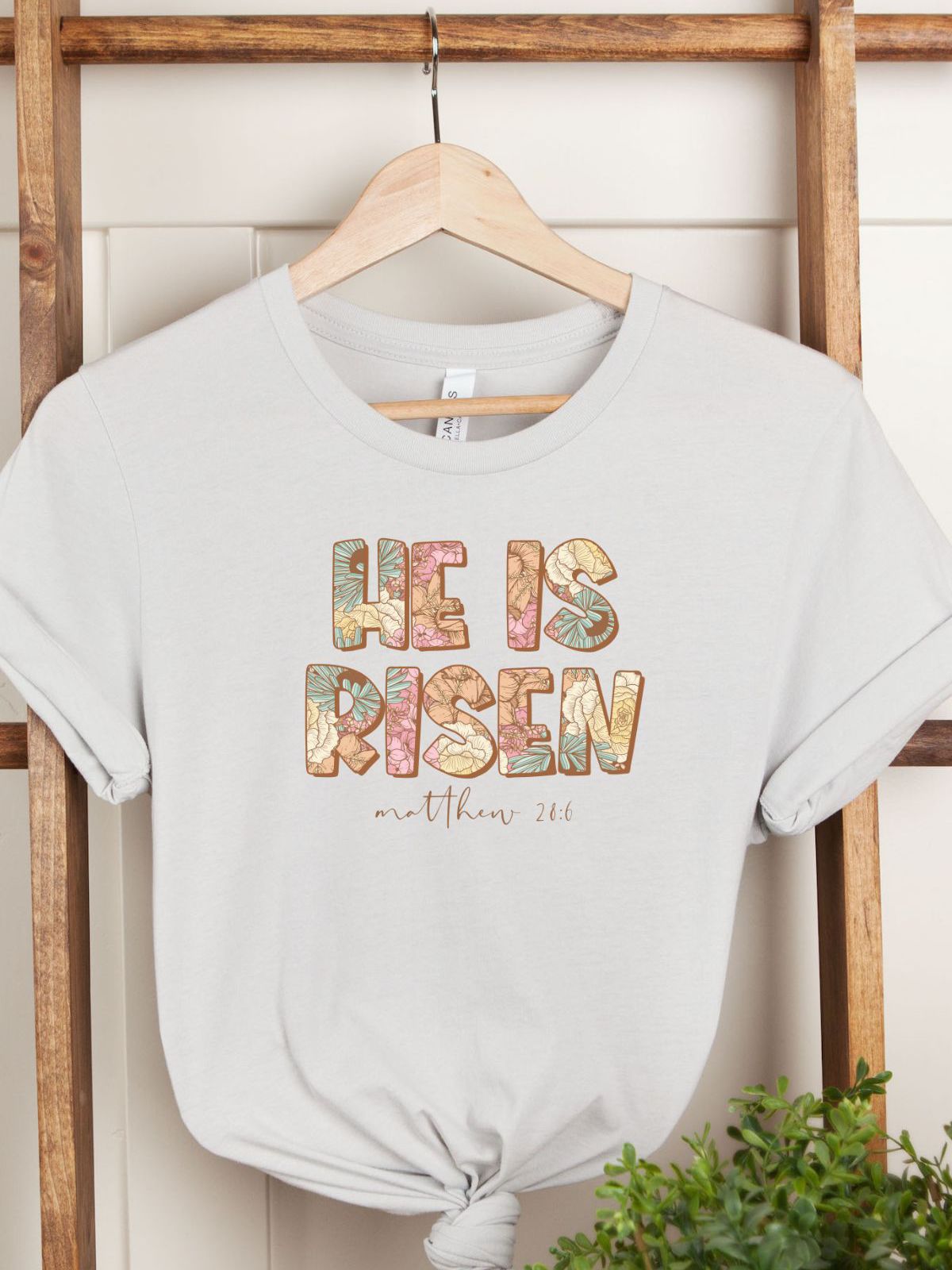 He is Risen graphic women's T-Shirt hanging