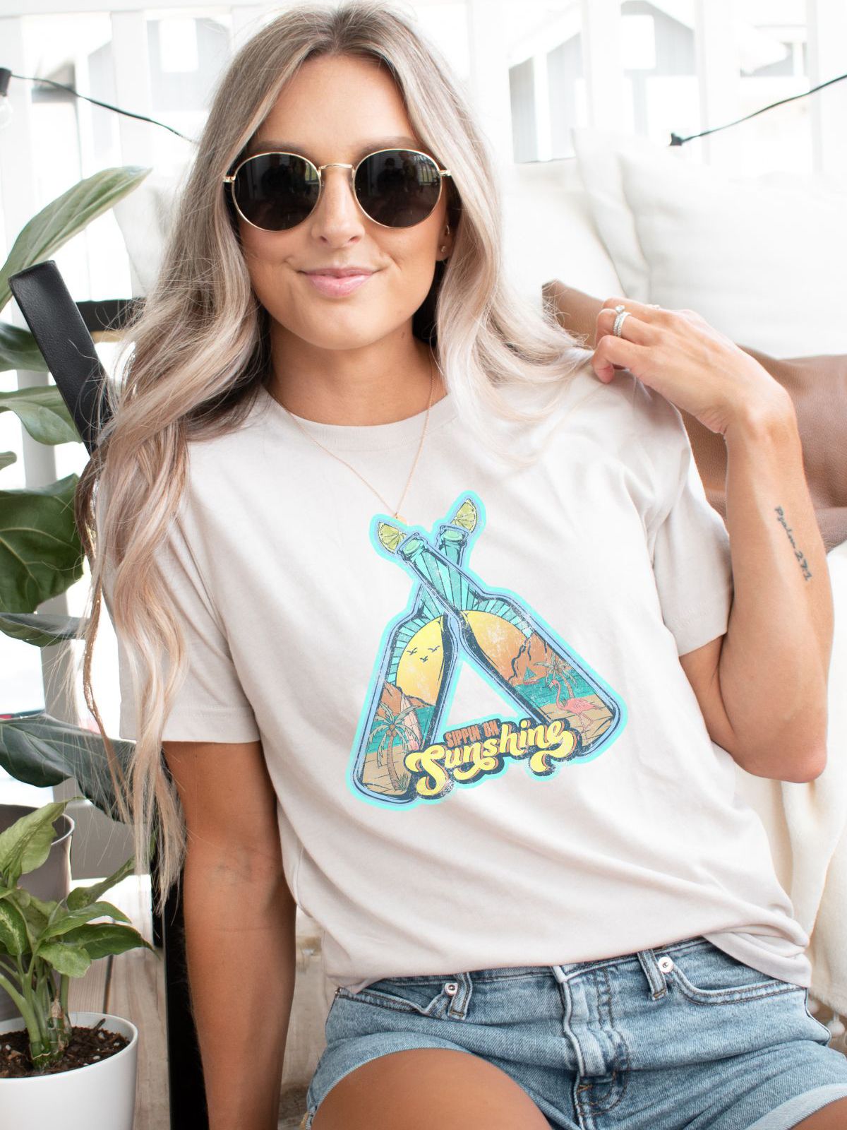 Woman wearing Sippin Sunshine graphic t-shirt
