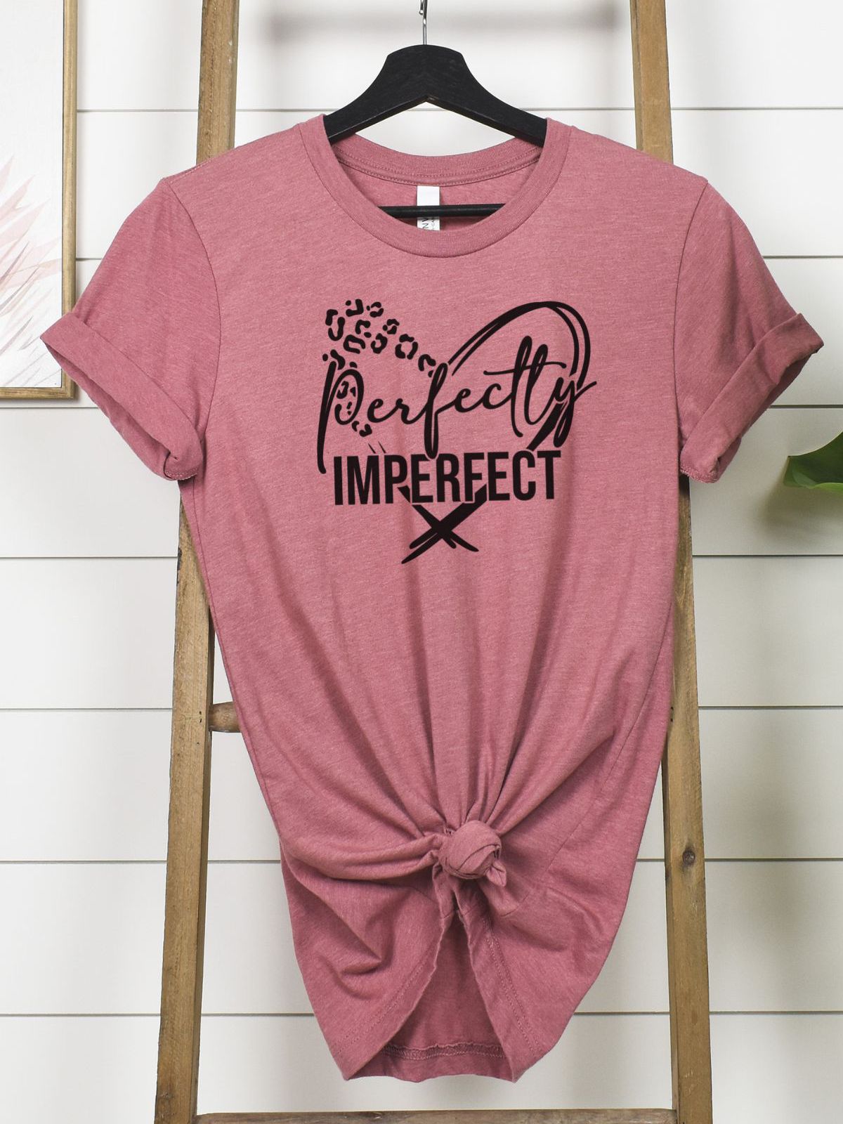 Perfectly Imperfect pink t-shirt hanging on a ladder
