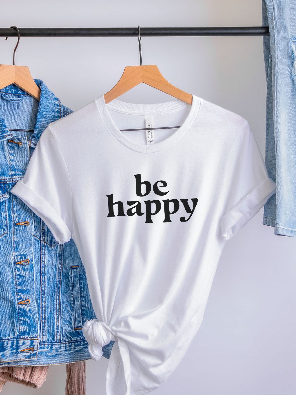 Be Happy white t-shirt on hanger