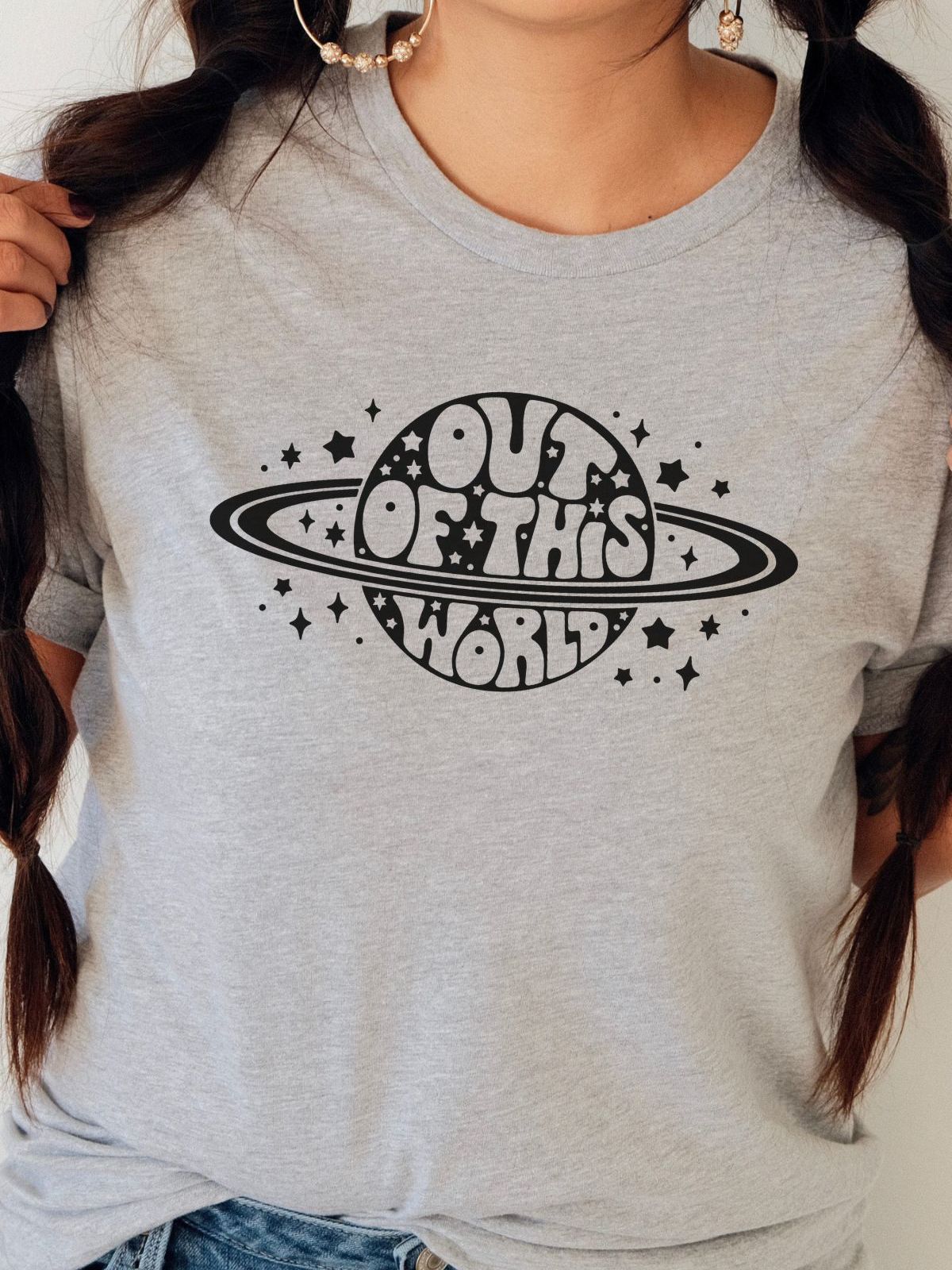 woman wearing gray t-shirt with Out of This World design